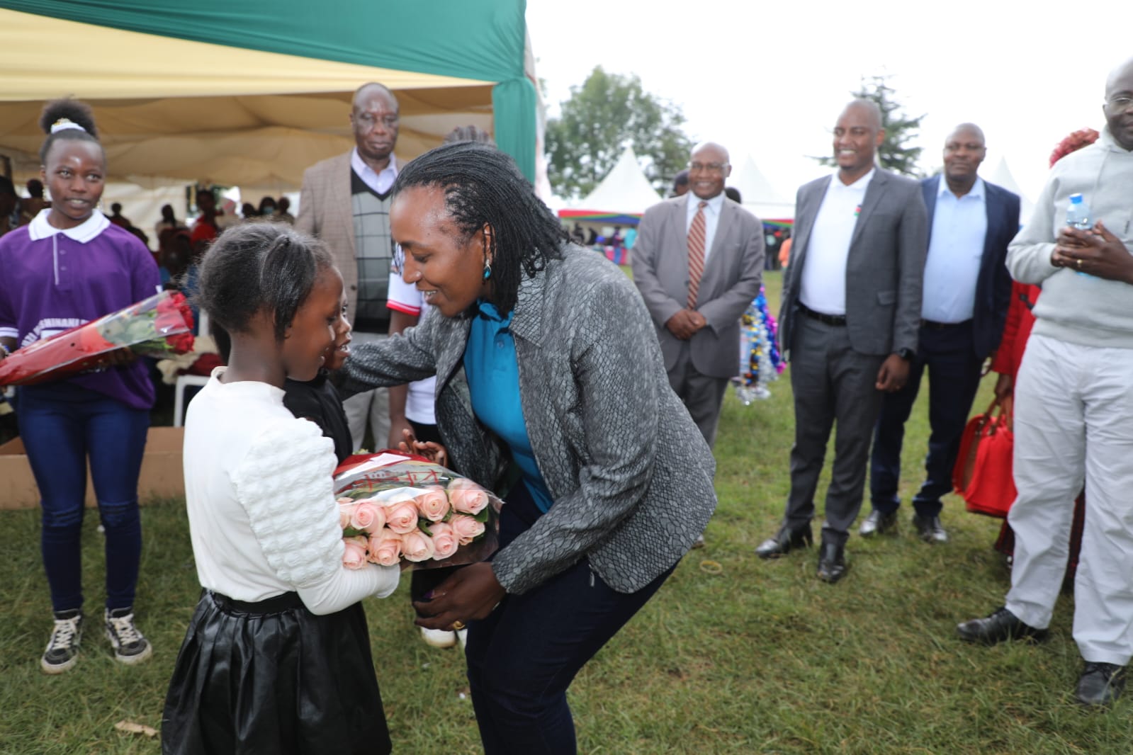 Ag CEO receiving a bouquet of flowers.